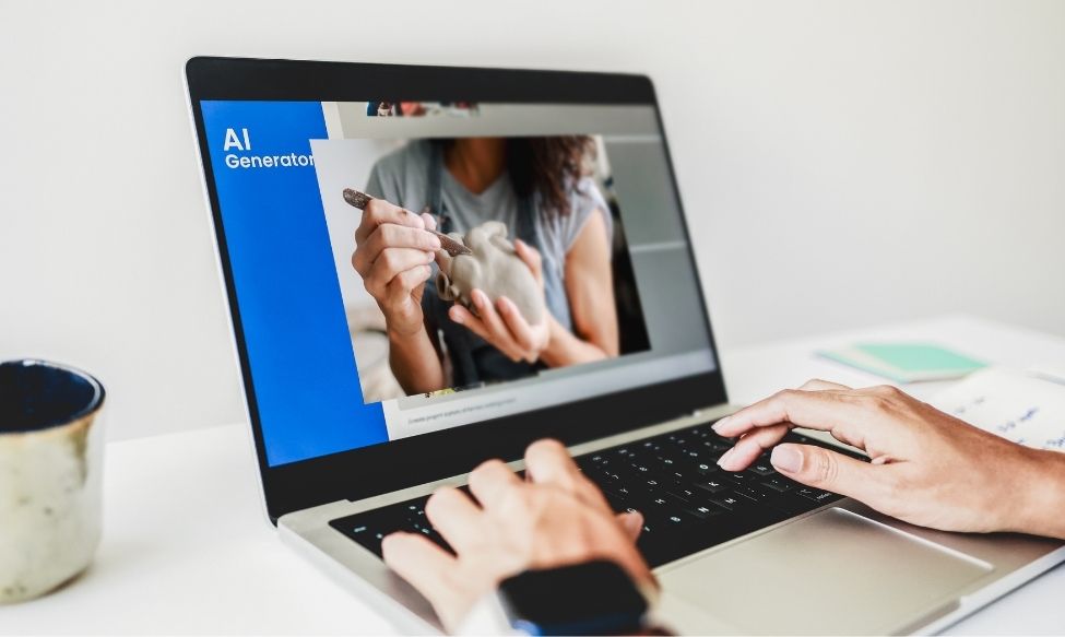 Person using an Answer Engine and AI generator tool on a laptop while viewing a photo of someone sculpting clay, representing creativity enhanced by artificial intelligence