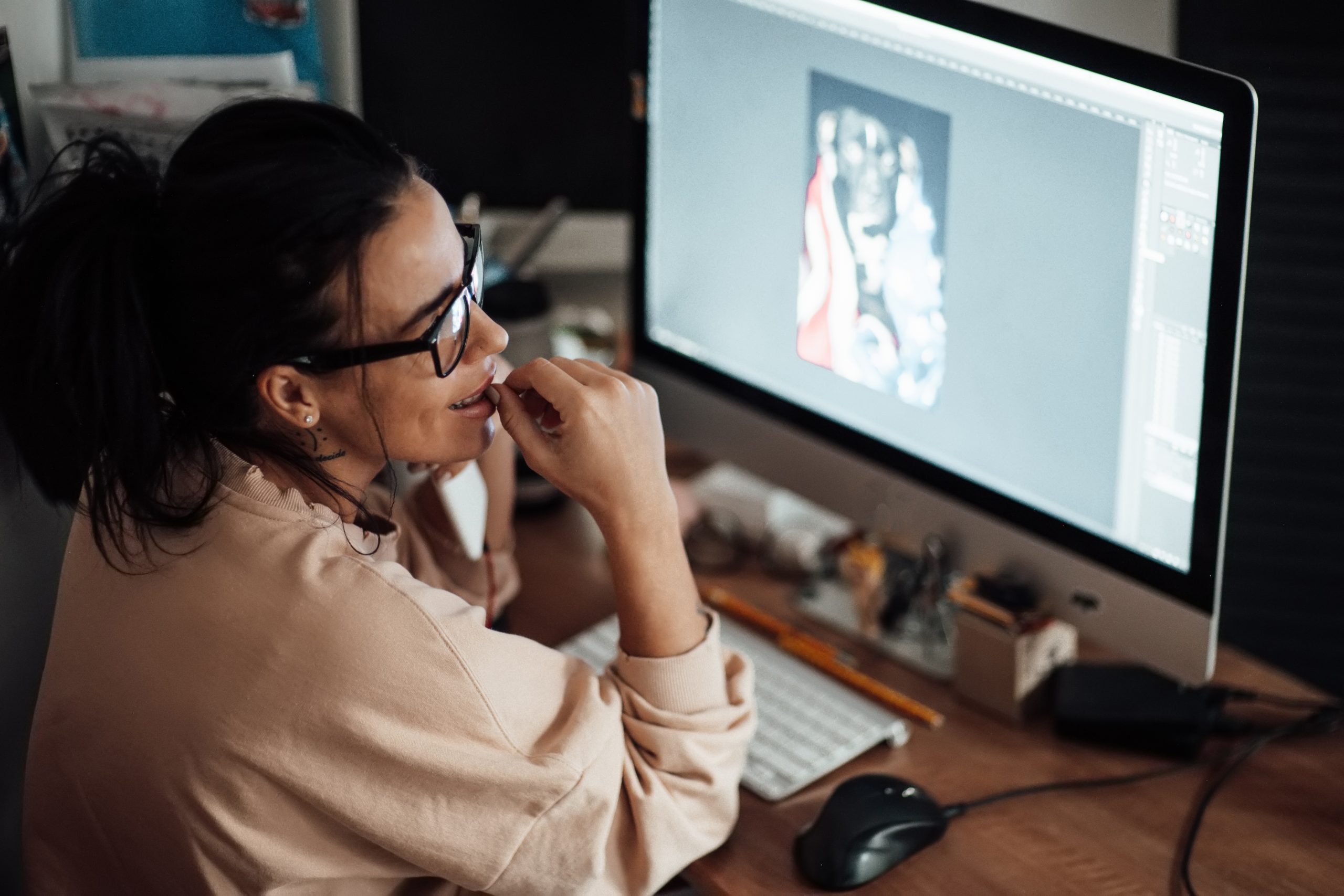 Designer reviewing digital creative on screen, representing AI marketing fatigue, brand strategy, content overload and modern marketing trends for Irish businesses in 2026